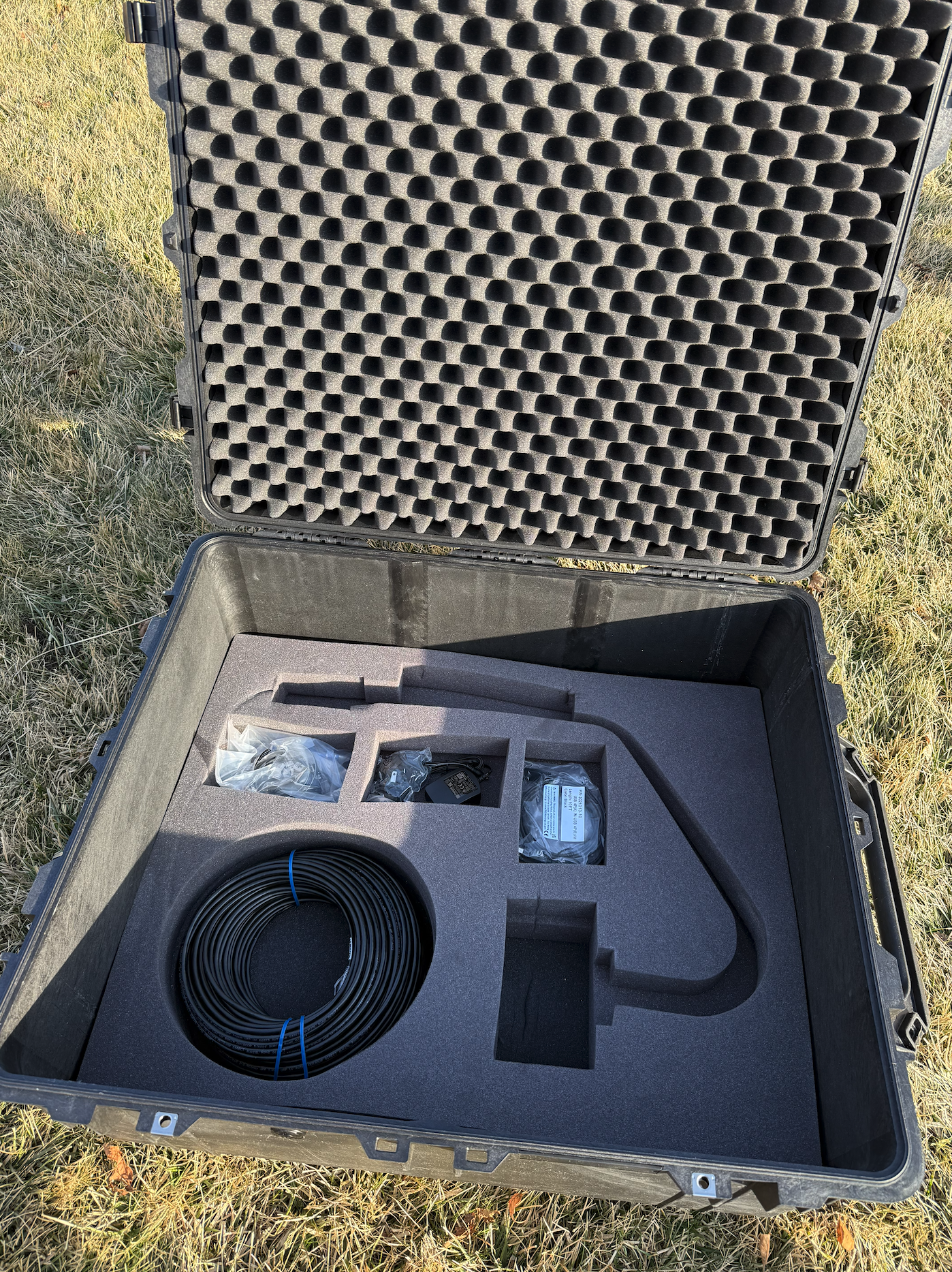 Pelican case with custom foam cutouts holding weather station equipment